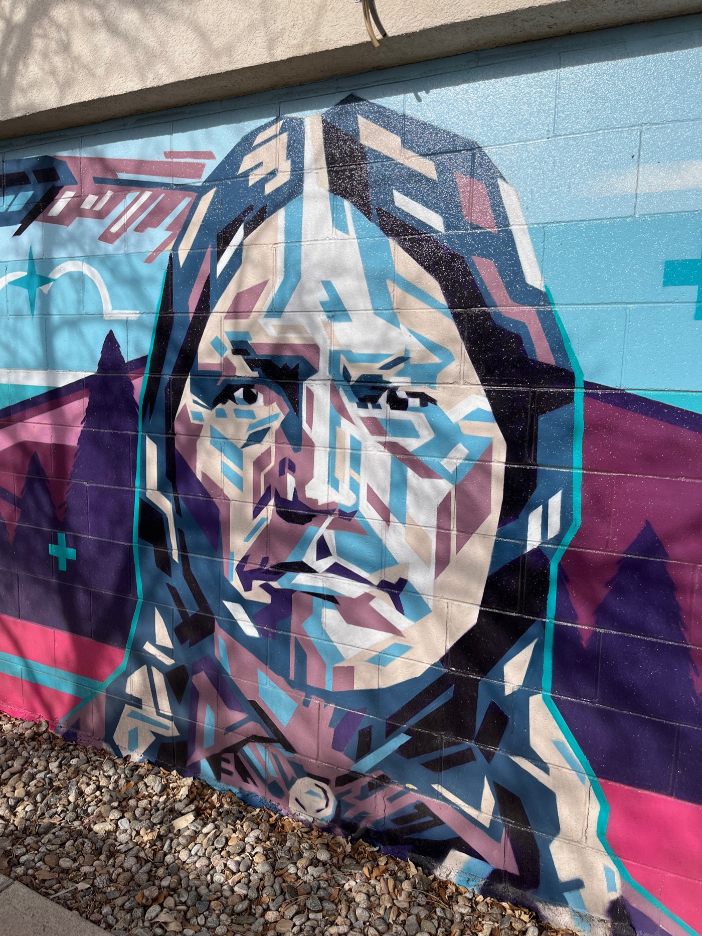 Geometric mural portrait of Chief Nowoo³ 'Niwot' on a building in Old Town Niwot, Colorado